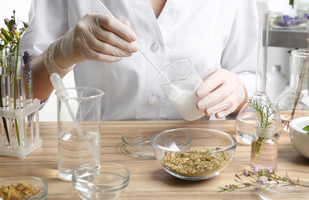 Scientist developing cosmetic product in laboratory, closeup